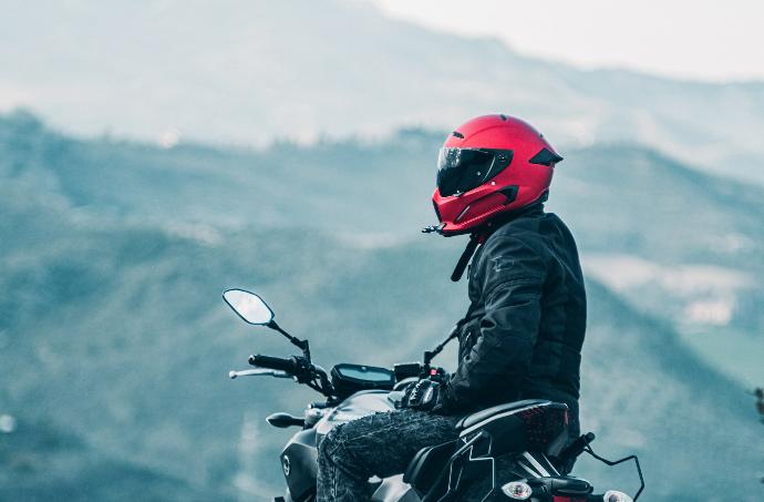 Rider a man riding a motorcycle with a mountain in the background